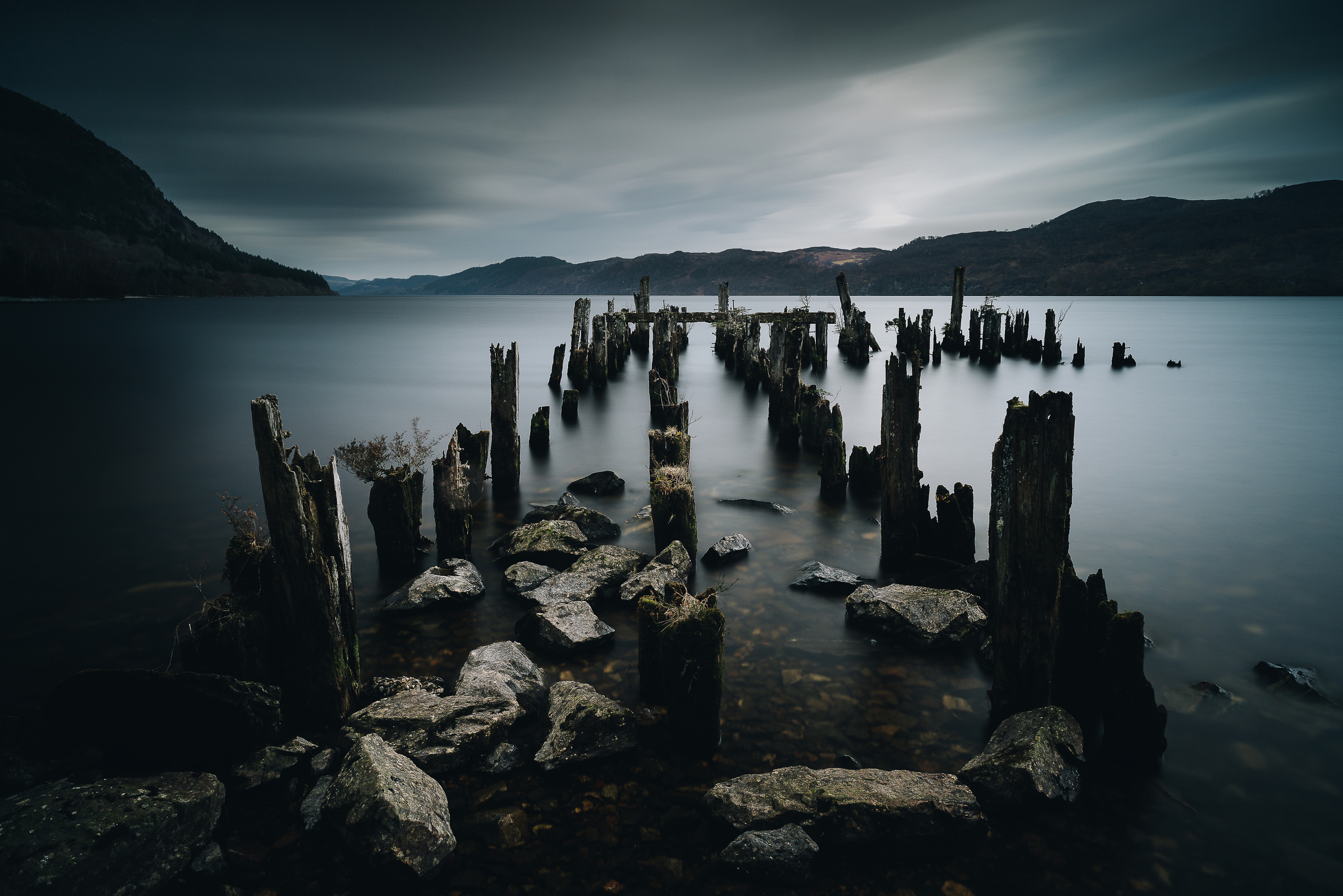 old pier posts, dark water