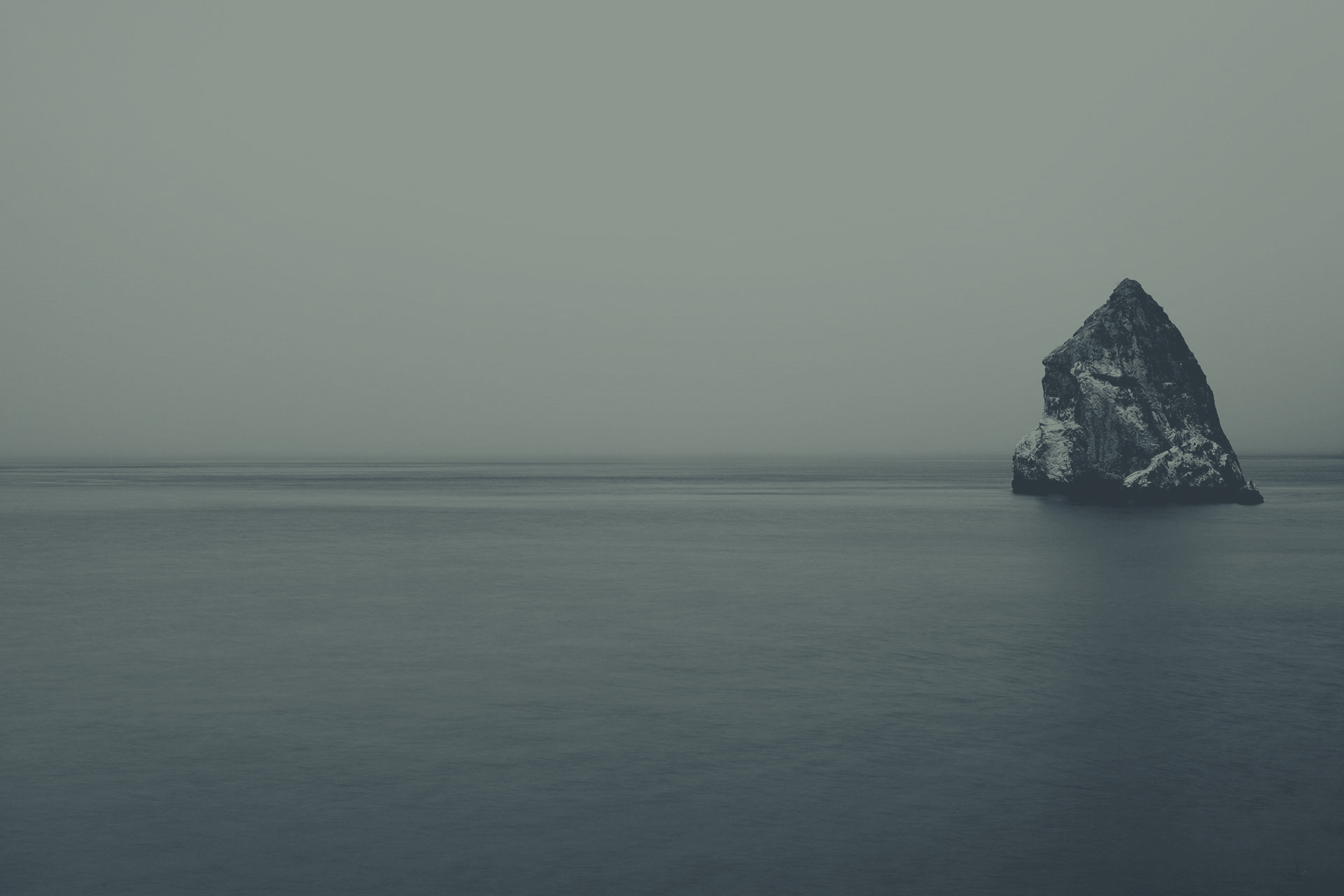 lone rock, grey sea
