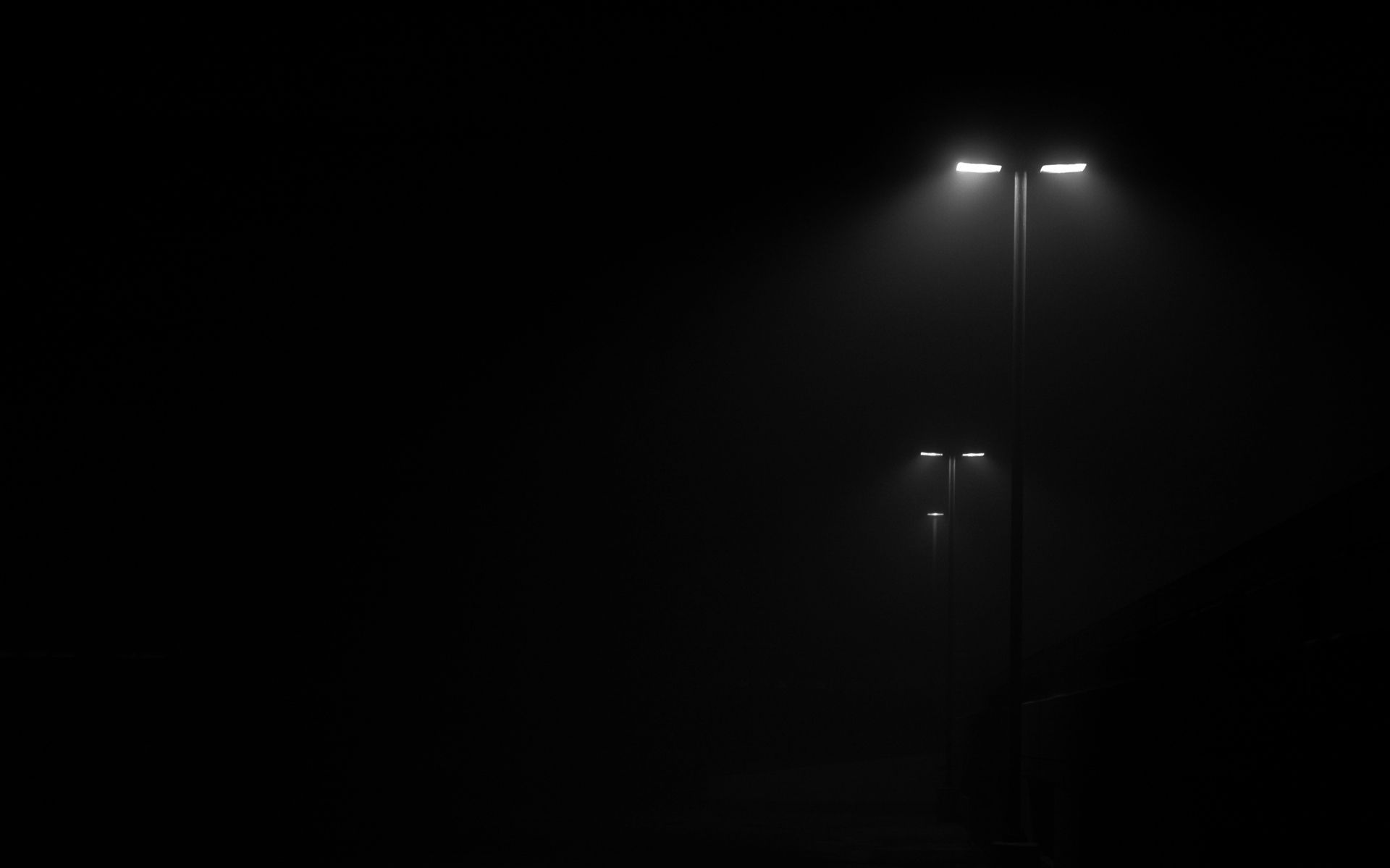street lights in fog, near-black